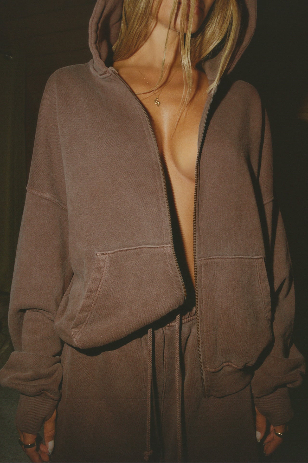 Front view of model posing in the oversized comfortable cedar french terry Oversized Zip Hoodie with a full length front zip closure, side pockets and thumbholes in the fitted cuffs