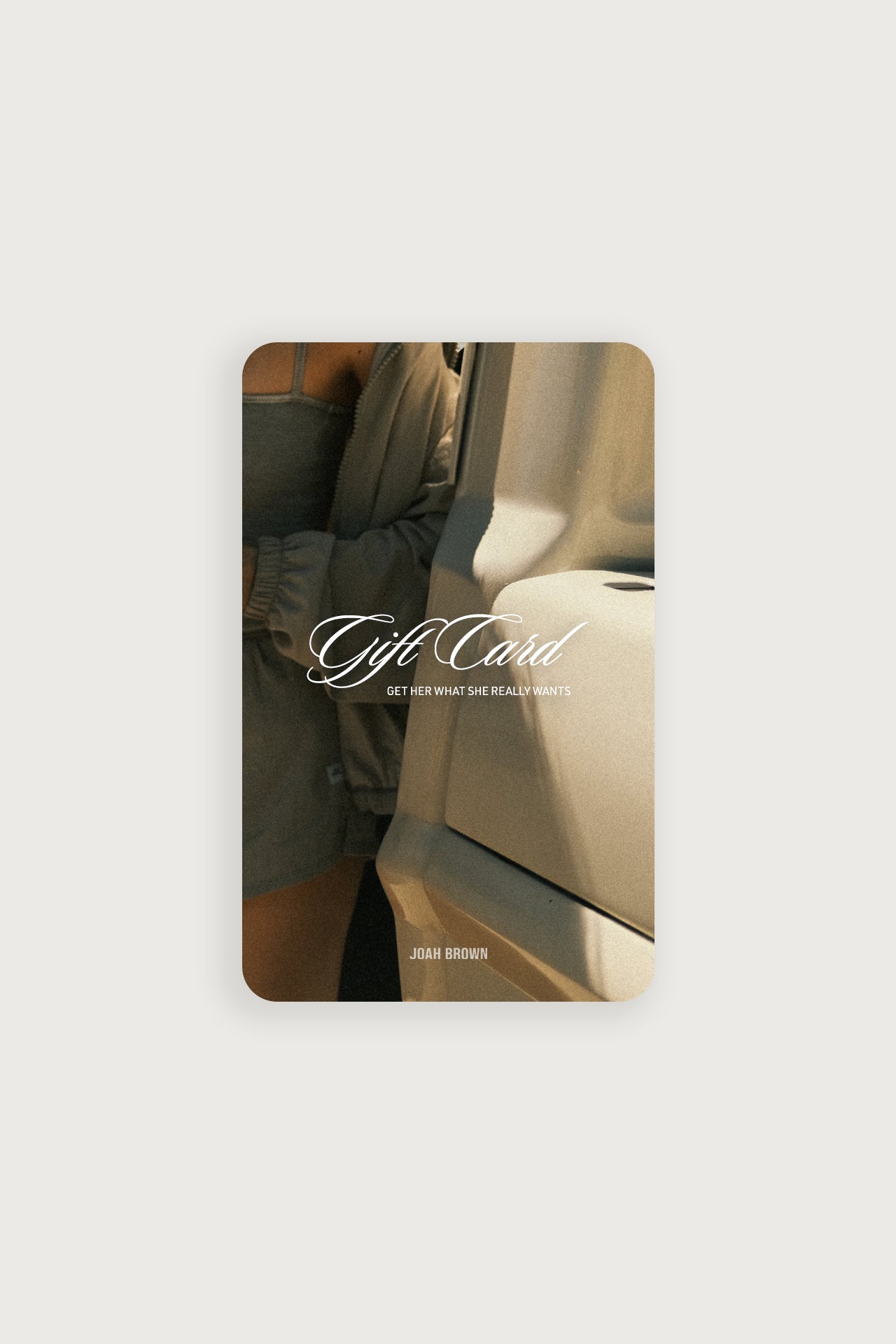 Front view of the JOAH BROWN gift card featuring the text: -Gift Card. Get her what she really wants- over a model getting out of a car