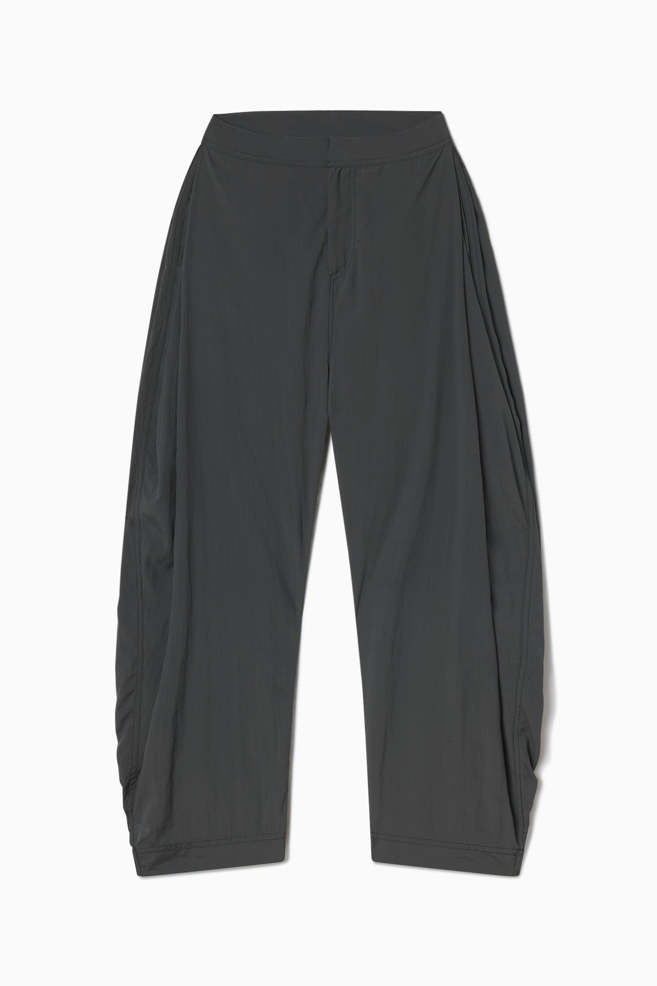 Flat lay front view of the oversized, horseshoe-style jet nylon Barrel Pant with side pockets, zip fly, pleated sides and adjustable snap closures at the ankle.