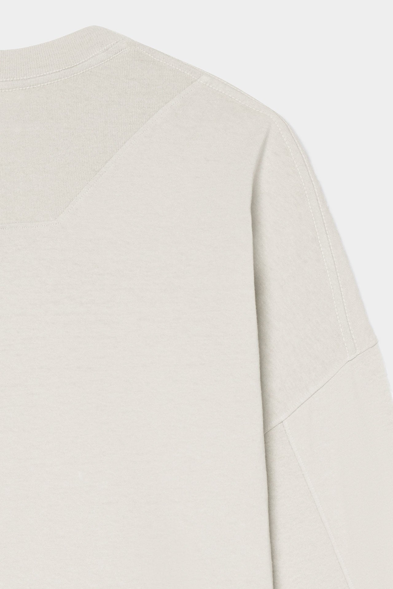 Detail back flat lay view of model posing in oversized fog cotton Vintage Long Sleeve top with a crew neckline and ribbed accents at the upper back