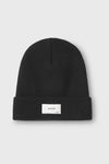 Flat lay front view of the warm knit black Official Beanie with a joah brown logo patch on the front