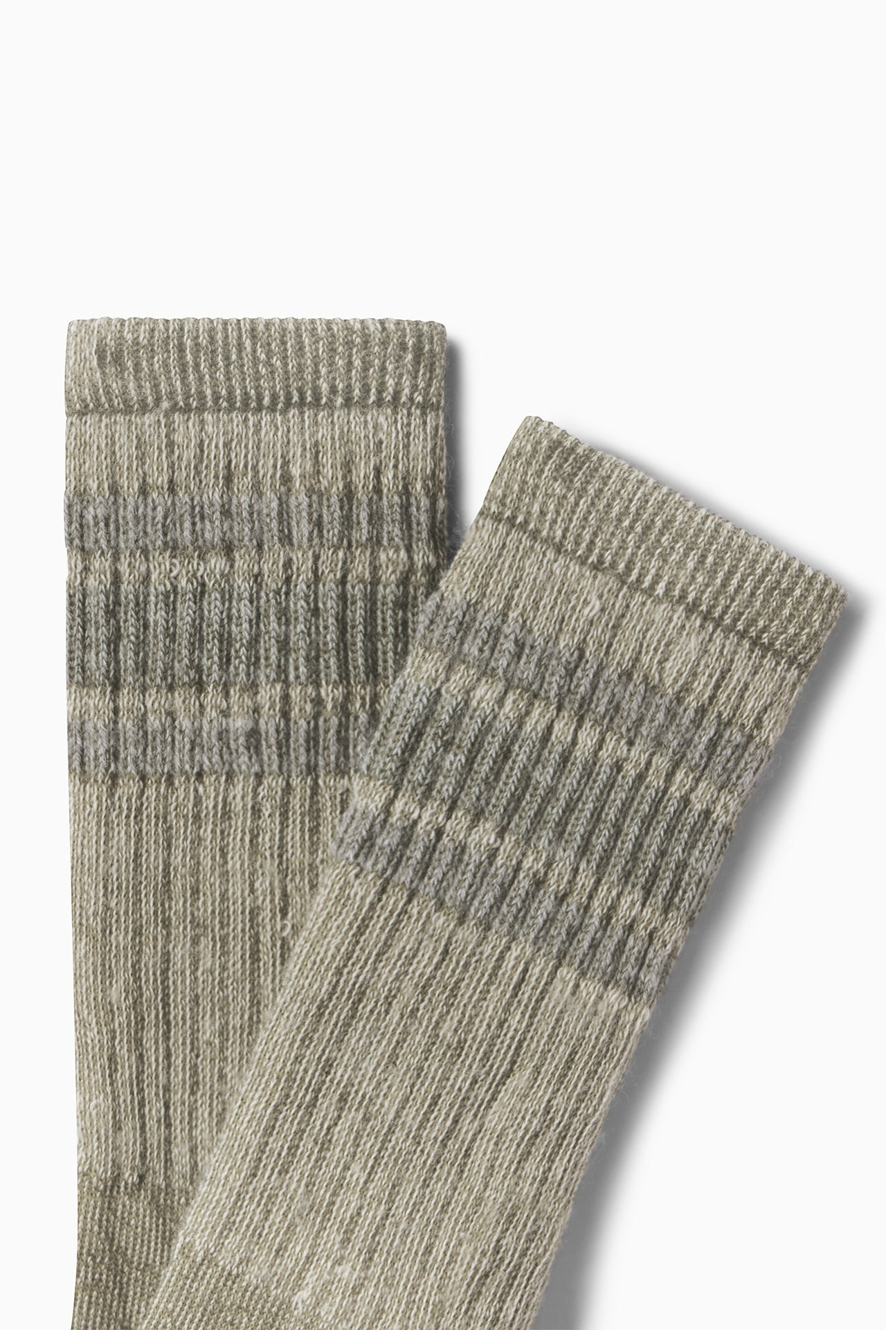 Close up flat lay side view of the crew-style ribbed and soft heathered olive Merino Stripe Sock