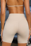 Close up detail back view of model from the waist down wearing the soft stretchy high-waisted sueded yuma Biker Short with a supportive, wide waistband
