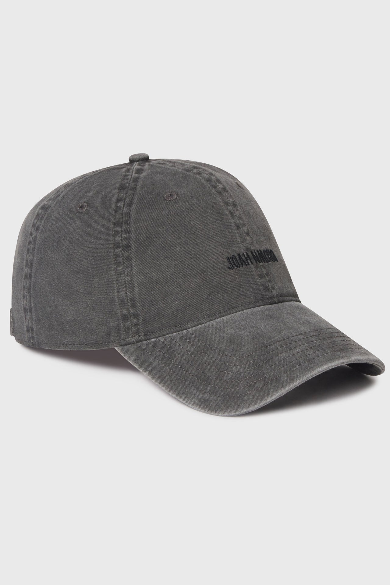 Flat lay side view of the six-panel washed black Official Cap with a curved brim and an embroidered upside down Joah Brown logo on the front