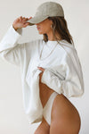 Side view of model posing in the oversized fog cotton Vintage Long Sleeve top with a crew neckline and ribbed accents