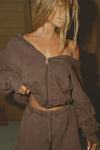 Front view of model posing in the oversized comfortable cedar french terry Oversized Zip Hoodie with a full length front zip closure, side pockets and thumbholes in the fitted cuffs
