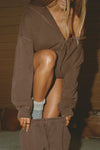 Front view of model posing in the oversized comfortable cedar french terry Oversized Zip Hoodie with a full length front zip closure, side pockets and thumbholes in the fitted cuffs