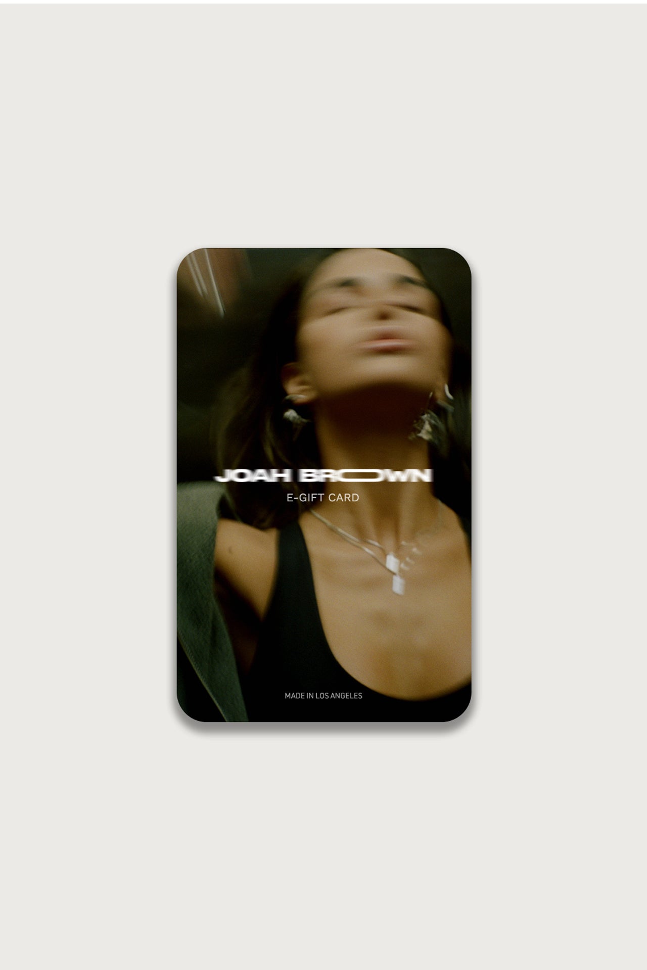 Front view of the Joah Brown gift card featuring a picture of a model posing in the background and the Joah Brown logo in the foreground 