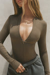 Close up front view of model posing in the form fitting woodland flexrib Invisible Zip Long Sleeve top with a 3/4 front invisible zipper and a crew neckline