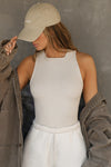 Front view of model posing in the fitted and stretchy dune flexrib High Square Neck Tank top with a high square neckline