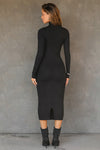 Full body back view of model posing in the fitted black rib Mock Neck Midi Dress with a mock turtleneck neckline, long sleeves, quarter zip back and a mid-calf length