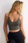 Front view of model posing in the fitted and stretchy mineral flexrib Strappy Crop Tank with thin straps and a scooped u neckline