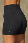 Close up detail back view of model from the waist down posing the soft and stretchy high-waisted sueded onyx 2.5 inch Body Short with a wide waistband and shortened 2.5 inch inseam