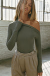 Front view of model posing in the fitted and lighweight spruce modal Asymmertical Long Sleeve top with an asymmetrical neckline and single-shoulder design