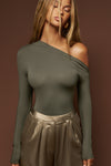 Front view of model posing in the fitted and lighweight spruce modal Asymmertical Long Sleeve top with an asymmetrical neckline and single-shoulder design