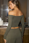 Back view of model posing in the fitted, slightly cropped spruce modal Bare Shoulder Long Sleeve top with a straight, off-the-shoulder neckline