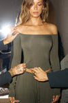 Front view of model posing in the fitted, slightly cropped spruce modal Bare Shoulder Long Sleeve top with a straight, off-the-shoulder neckline