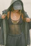 Front view of model posing in the reversible full-length sheer graphite mesh Bare Tank with a classic scoop neckline and vertical seam detail down the middle