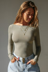 Front view of model posing in the fitted, light weight sage modal Boatneck Long Sleeve with a boat neckline
