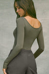 Back view of model posing in the fitted, lightweight spruce modal Boatneck Long Sleeve with boat neckline and scoop back