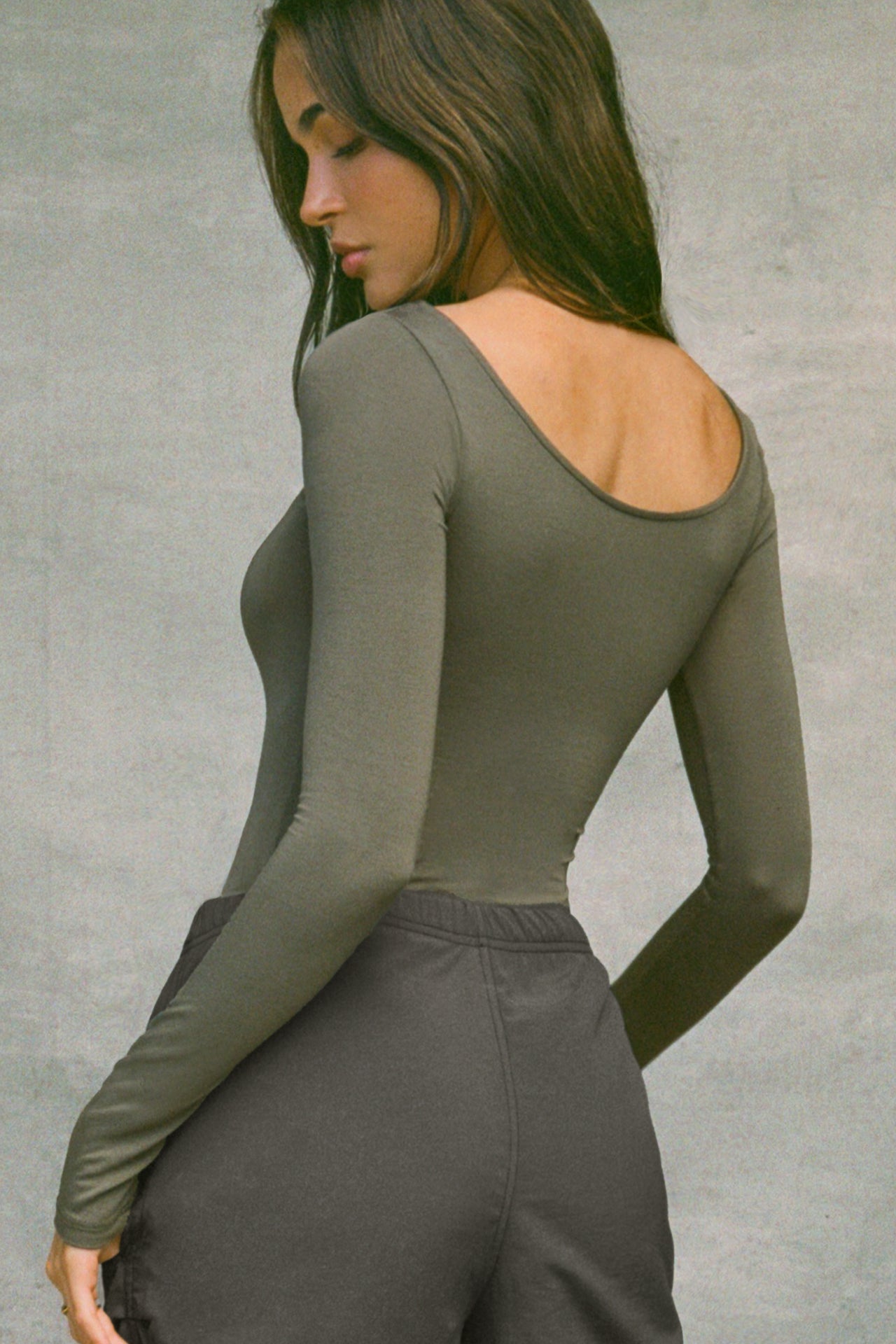 Back view of model posing in the fitted, lightweight spruce modal Boatneck Long Sleeve with boat neckline and scoop back