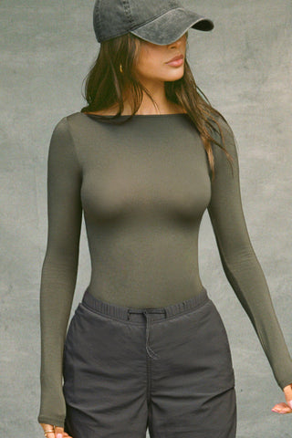 Front view of model posing in the fitted, lightweight spruce modal Boatneck Long Sleeve with a boat neckline