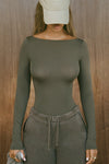 Front view of model posing in the fitted, lightweight spruce modal Boatneck Long Sleeve with a boat neckline