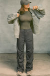 Full body front view of model posing in the fitted, lightweight spruce modal Boatneck Long Sleeve with a boat neckline