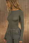 Front view of model posing in the fitted, lightweight spruce modal Boatneck Long Sleeve with a boat neckline