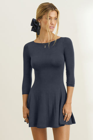 Front view of model posing in the fitted, mini-length navy modal Boatneck Mid-Sleeve Dress with a boat neckline, mid-length sleeves and A-line silhoutte 