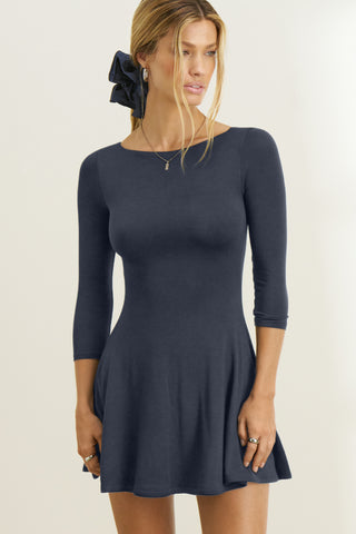 Front view of model posing in the fitted, mini-length navy modal Boatneck Mid-Sleeve Dress with a boat neckline, mid-length sleeves and A-line silhoutte 