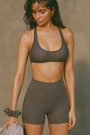 Front view of model posing in the soft and stretchy high-waisted sueded carob 2.5 inch Body Short with a wide waistband and shortened 2.5 inch inseam
