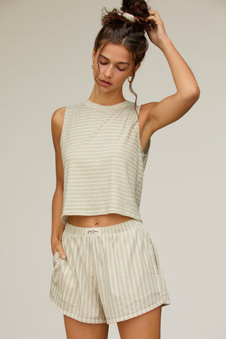 Front view of model posing in the sage stripe classic cotton boxer-inspired Boxer Short in a relaxed silhouette, with an elastic waistband and side pockets.