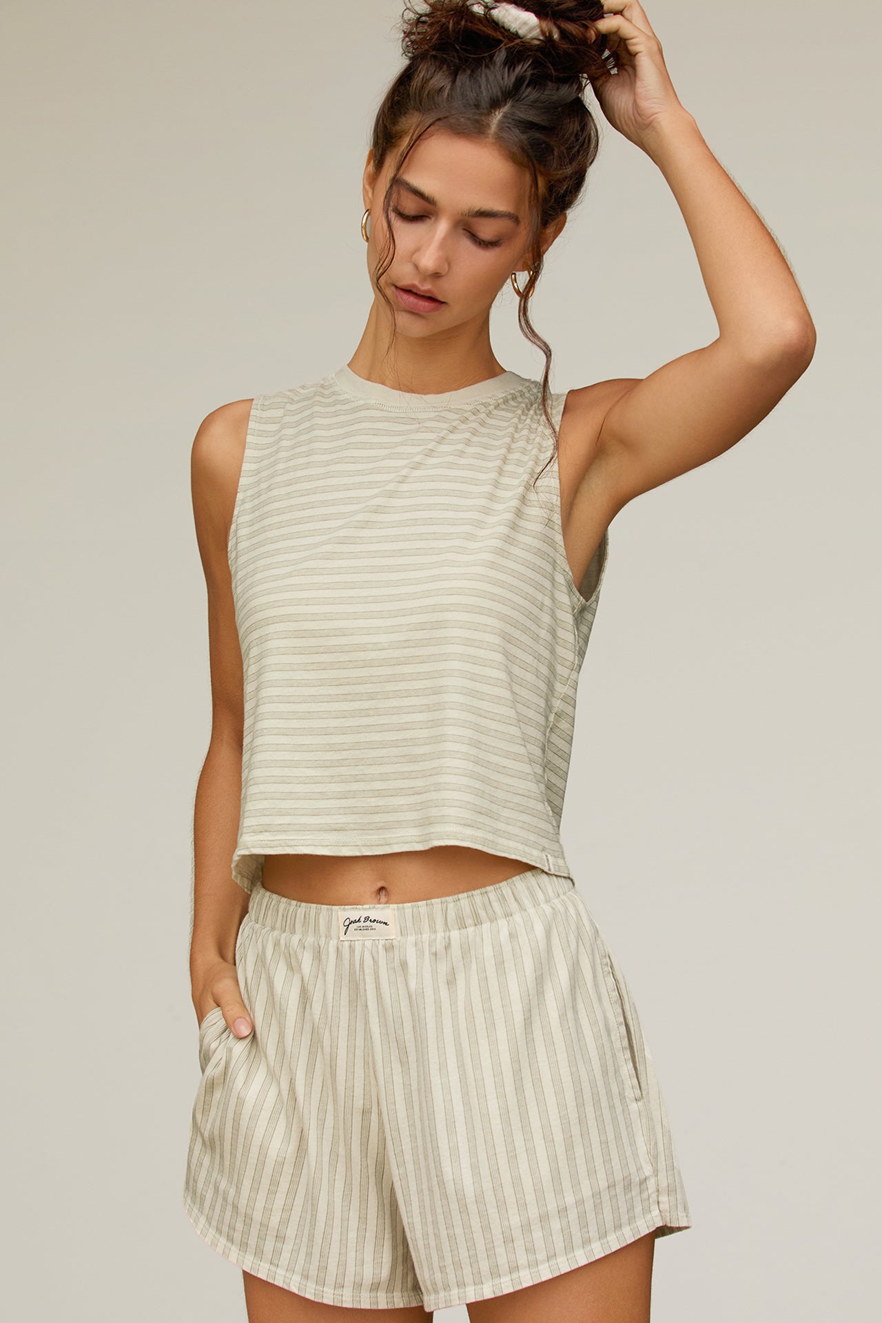Front view model posing in the relaxed fit sage stripe classic cotton Muscle Tank with a crew neckline
