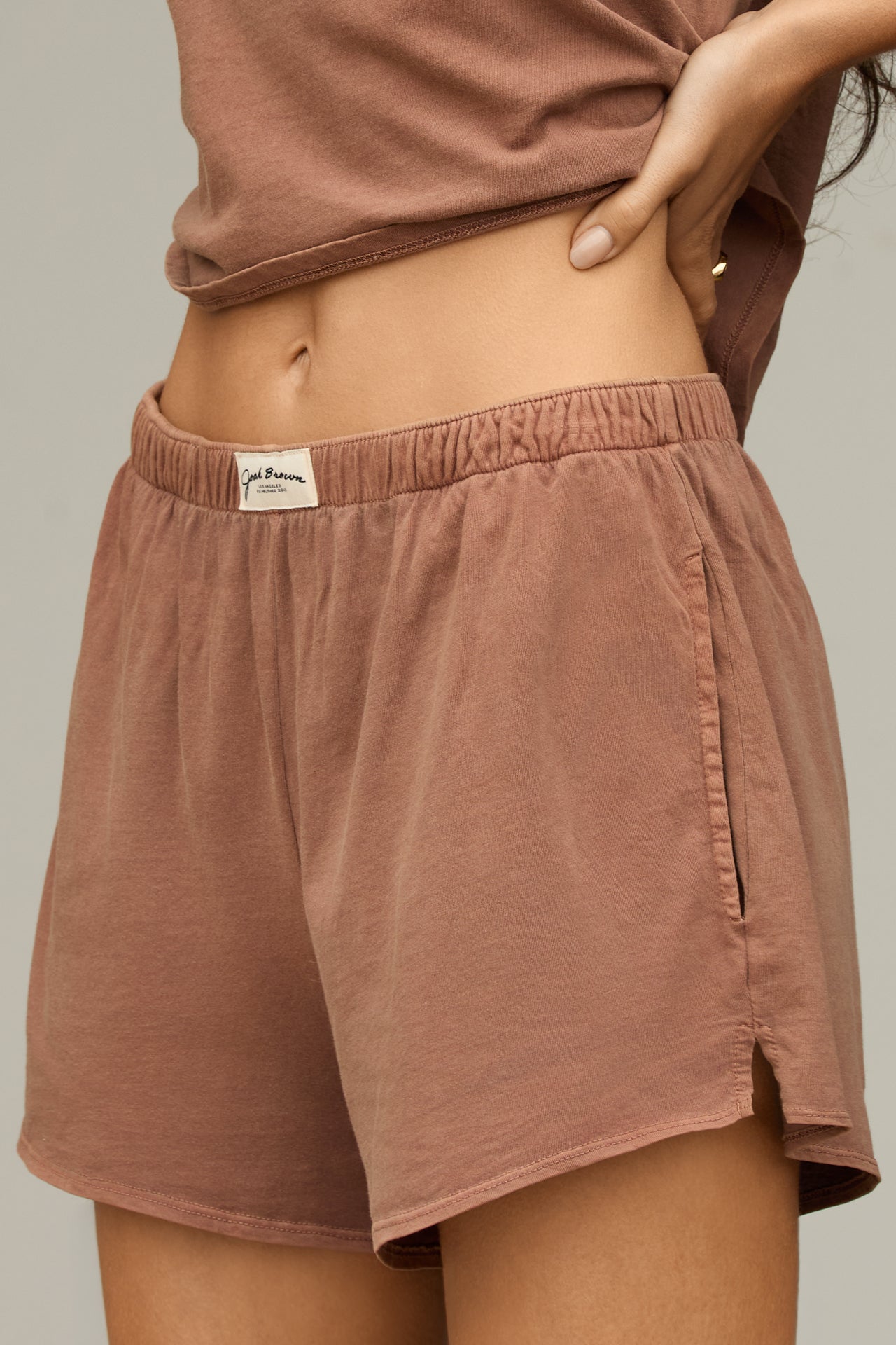 Close up side view of model from the waist down posing in the tobacco classic cotton boxer-inspired Boxer Short in a relaxed silhouette, with an elastic waistband and side pockets.