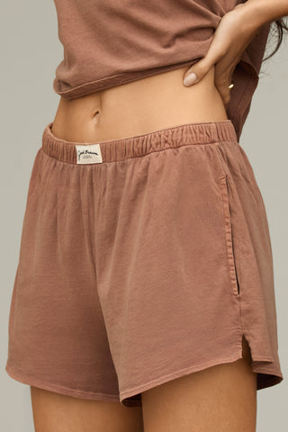 Close up side view of model from the waist down posing in the tobacco classic cotton boxer-inspired Boxer Short in a relaxed silhouette, with an elastic waistband and side pockets.