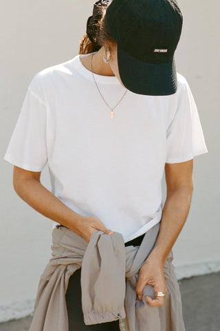 Front view of model posing in the relaxed fit, lightweight optic white classic cotton Boxy Tee with a crew neckline and short sleeves