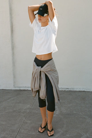 Full body view of model posing in the relaxed fit, lightweight optic white classic cotton Boxy Tee with a crew neckline and short sleeves