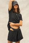 Front view of model posing in the relaxed fit black modal Boyfriend Tee with a crew neckline