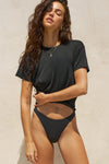 Front view of model posing in the relaxed fit black modal Boyfriend Tee with a crew neckline