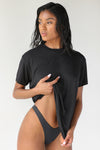 Front view of model posing in the relaxed fit black modal My Boys Tee with a crew neckline