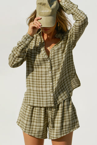 Front view of model posing in the lightweight orchard gauze Classic Button Down collared long sleeve shirt with front button closures