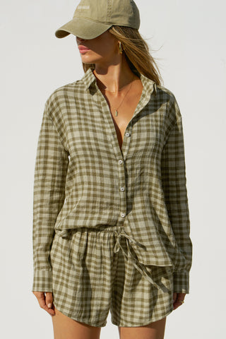 Front view of model posing in the lightweight orchard gauze Classic Button Down collared long sleeve shirt with front button closures
