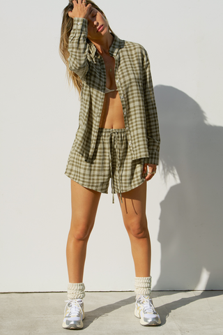 Full body front view of model posing in the relaxed fit lightweight orchard gauze Relaxed Everyday Short with an elastic waistband and adjustable front tie