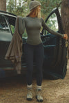Front view of model posing outside by a car in the fitted and lightweight spruce modal Classic Crew Long Sleeve top with a crew neckline