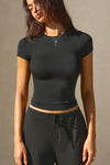 Front view of model posing in the lightweight and fitted black modal Classic Crew Tee shirt with a classic crew neckline and short sleeves.