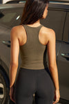 Back view of model posing in the woodland flexrib Classic Racerback Tank with a scoop neckine and racerback silhouette. 