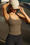 Front view of model posing in the woodland flexrib Classic Racerback Tank with a scoop neckine and racerback silhouette. 