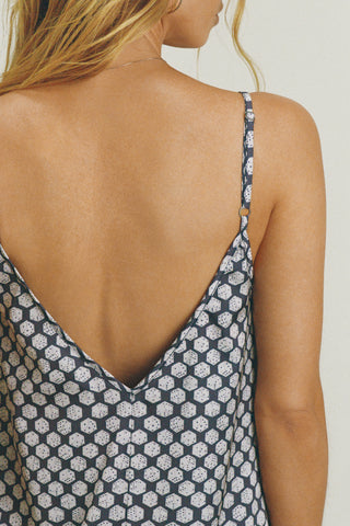 Close up back view of model posing in the relaxed fit navy dice satin Classic Slip Dress delicate adjustable straps, a v-neckline and deep v-back