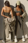 Two models posing sueded carob tops and leggings